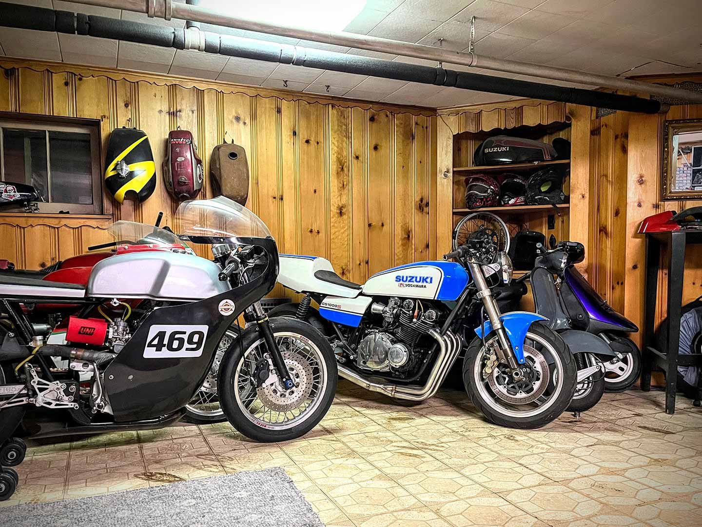 Motorcycles lurk mere feet under the living room. Matt Joy’s Honda CB350, Ducati single hidden behind, along with a Suzuki GS1000 Wes Cooley replica and sundry scooters.