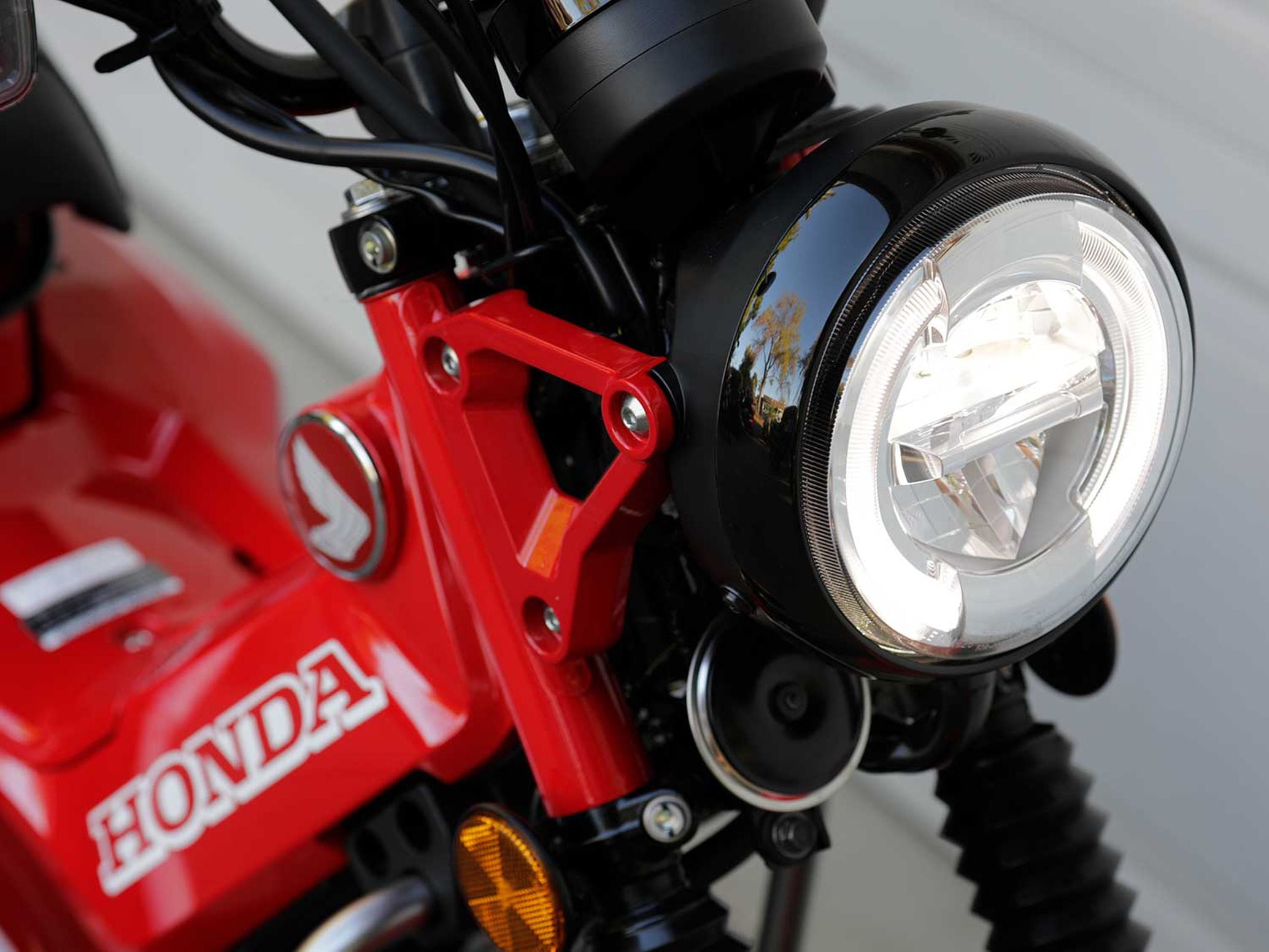 We are big fans of the Honda Trail 125’s bright LED lighting. Not only is it functional, but it pays homage to past iterations of Honda’s dual-sport Trail bikes.