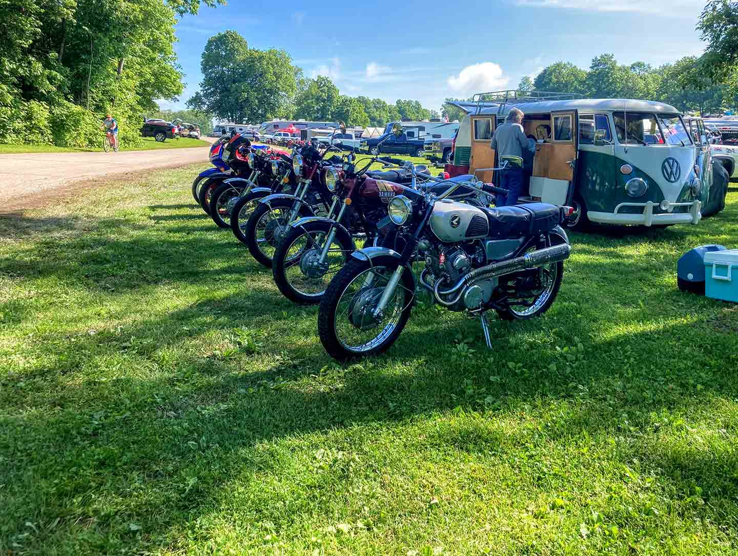 Which bike to bring? This is America, bring ’em all. Matching vintage VW bus with scramblers and other assorted vintage motorcycles.