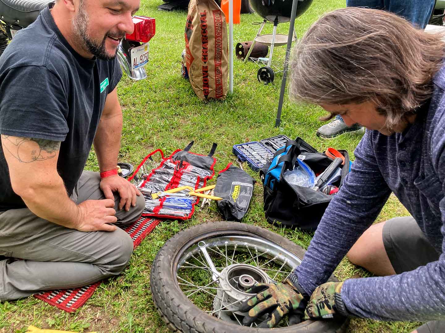 Even pitbikes need pit crews. While racers changed tires with shelter and fancy tools, others did it in Saturday’s wet grass.